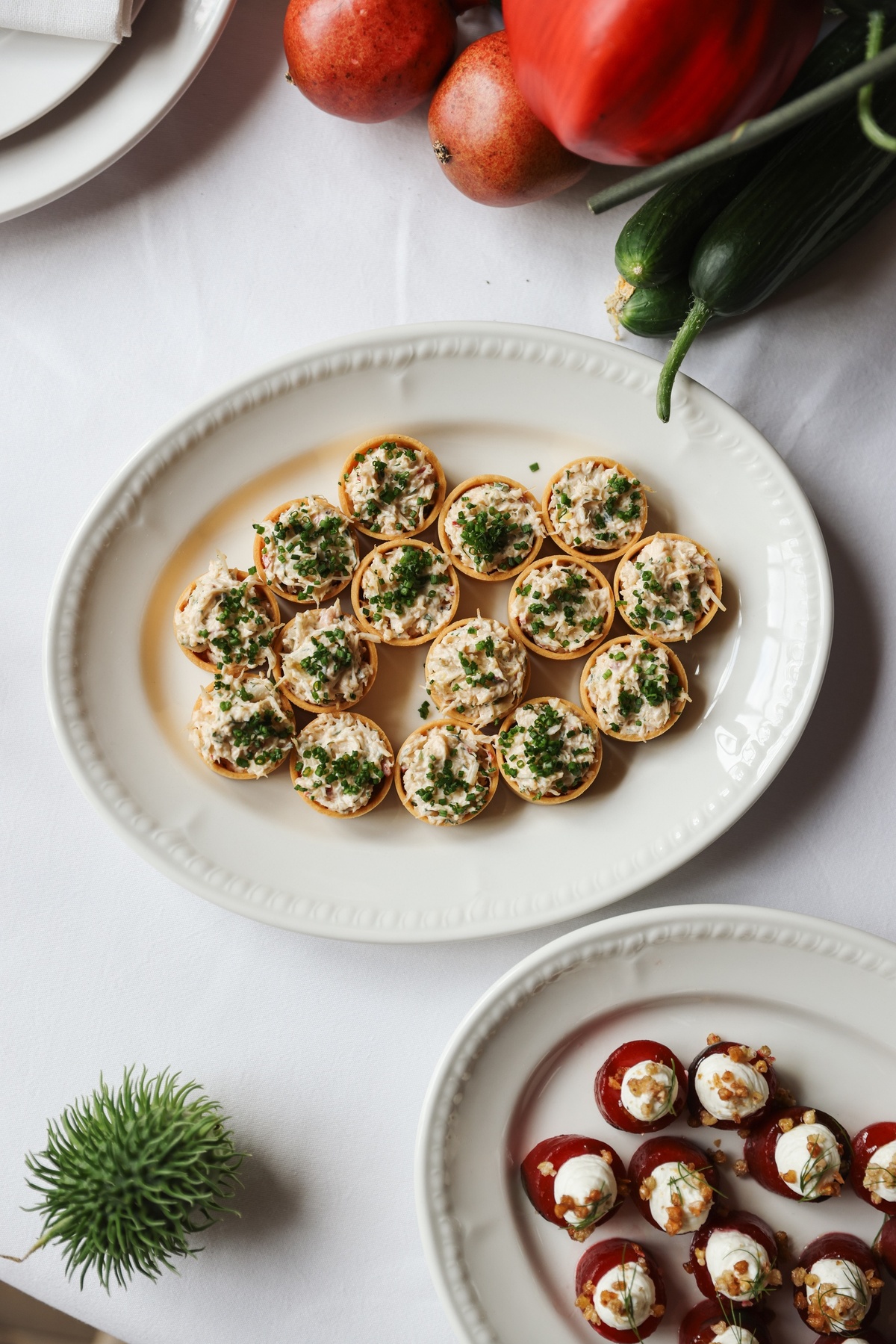 White platter of festive canapés with crab filling and herbs, served at Maslow’s in London for Christmas parties and private events