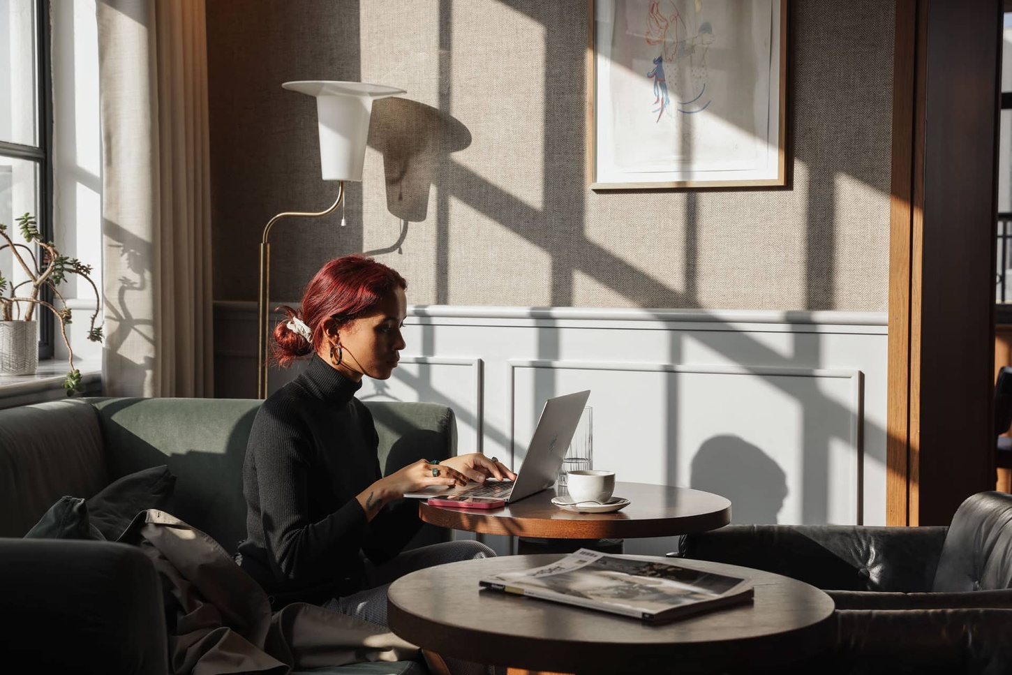 Woman working at Mortimer House in a well lit, wellness focussed work space
