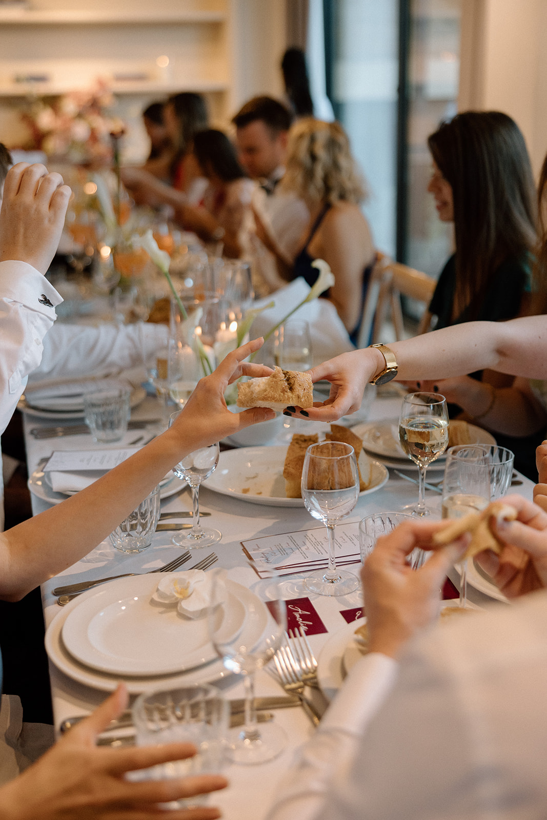 Photography by Danielle Victoria | Wedding guests sharing food and conversation during a wedding breakfast at an intimate wedding reception venue in Fitzrovia, London.