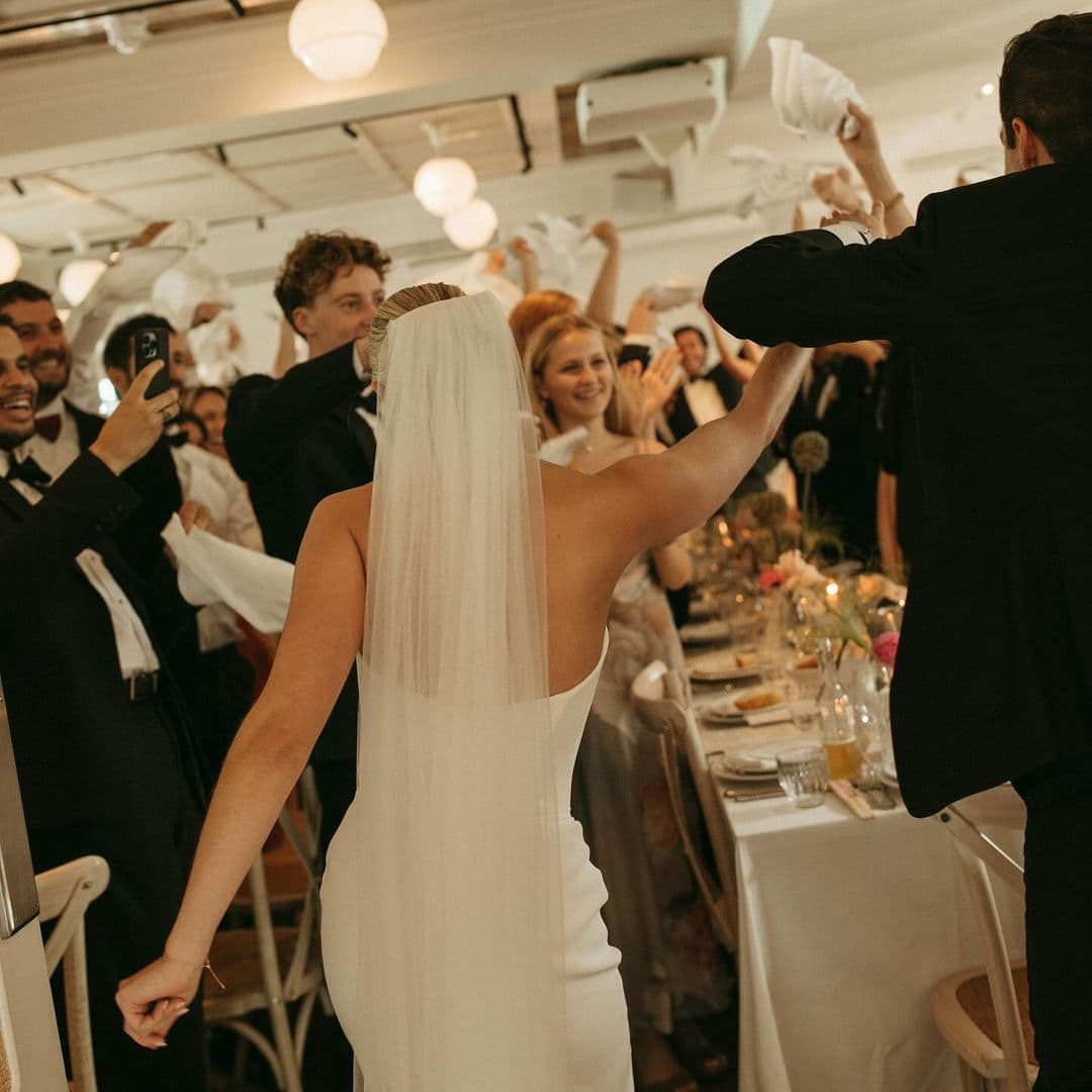 Photography by Alba Turnbull | Wedding guests waving napkins during a lively wedding breakfast celebration at an intimate wedding reception venue in Fitzrovia, London.