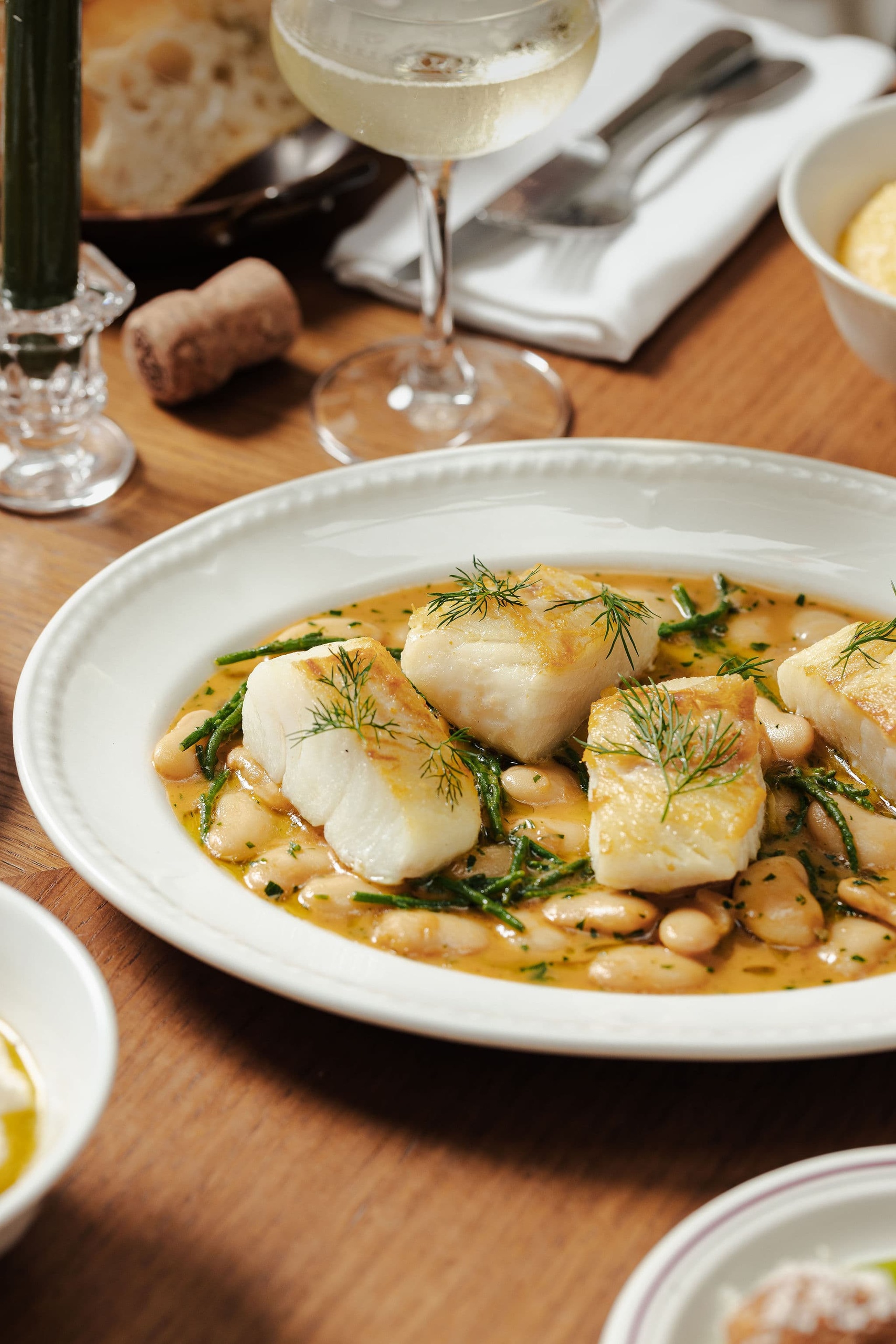 Seasonal wedding feast featuring beautifully plated fish and sharing-style dining at Mortimer House in Fitzrovia, London.