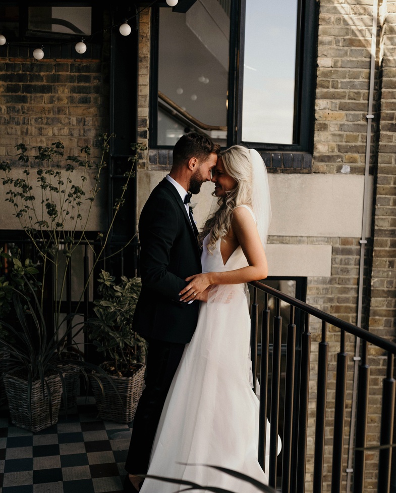 Photography by Alba Turnbull | Newly married couple sharing a quiet moment at Mortimer House, an intimate wedding venue in Fitzrovia, London