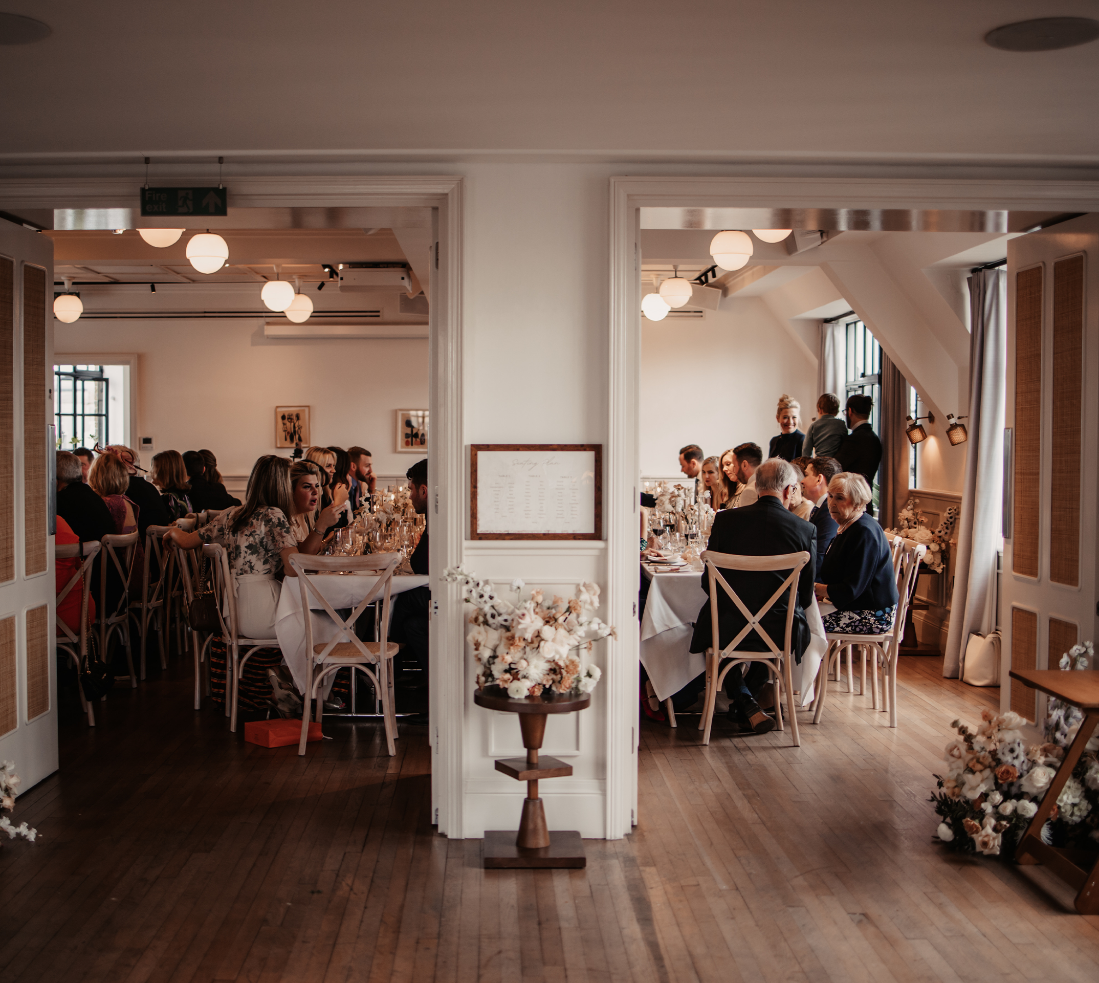 Guests seated for a wedding breakfast in the Loft and Gallery event spaces at Mortimer House, an intimate wedding venue in Fitzrovia, London.