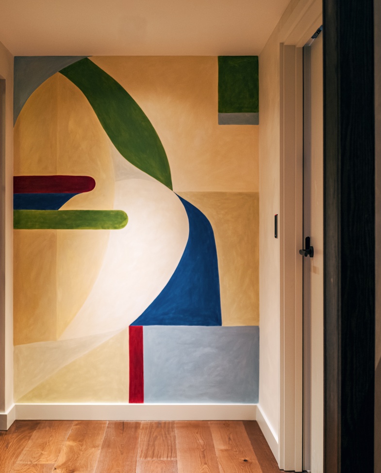 Geometric mural by Elsie Agnew near a meeting room at Maslow's Kensington